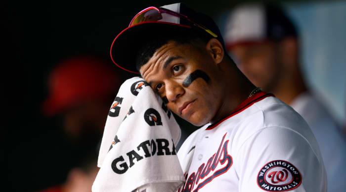Washington Nationals’ Juan Soto wipes his face in the dugout before a baseball game against the Atlanta Braves, Sunday, July 17, 2022, in Washington.